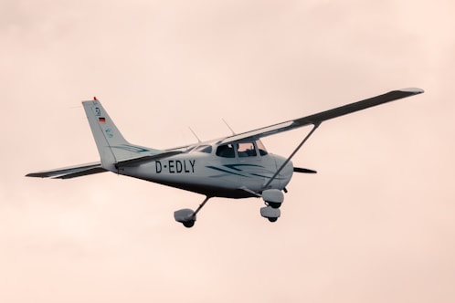 a small propeller plane flying through a cloudy sky