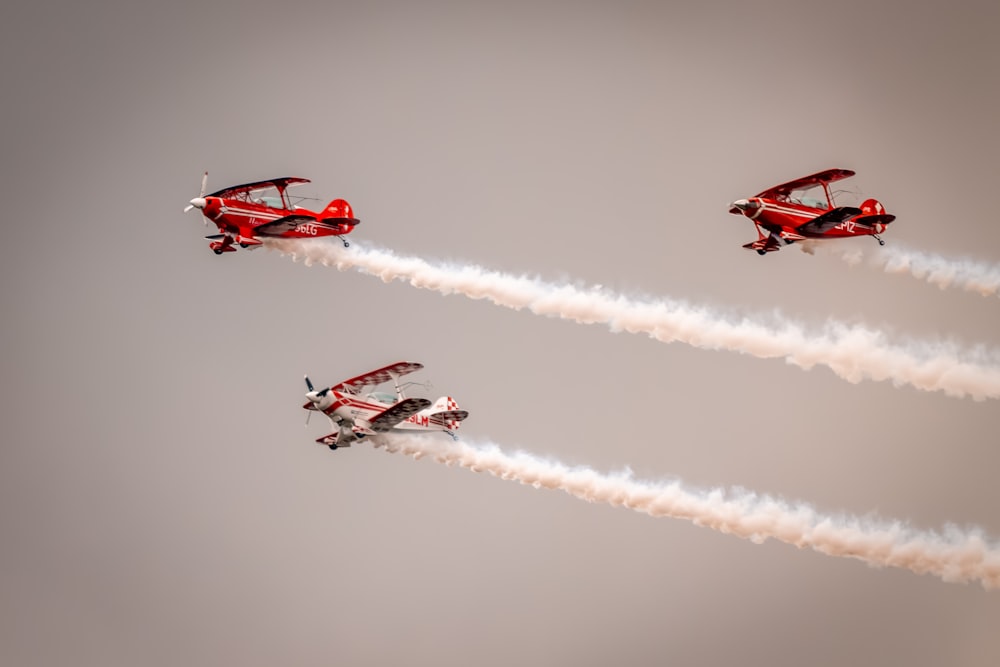 a group of airplanes flying through a cloudy sky