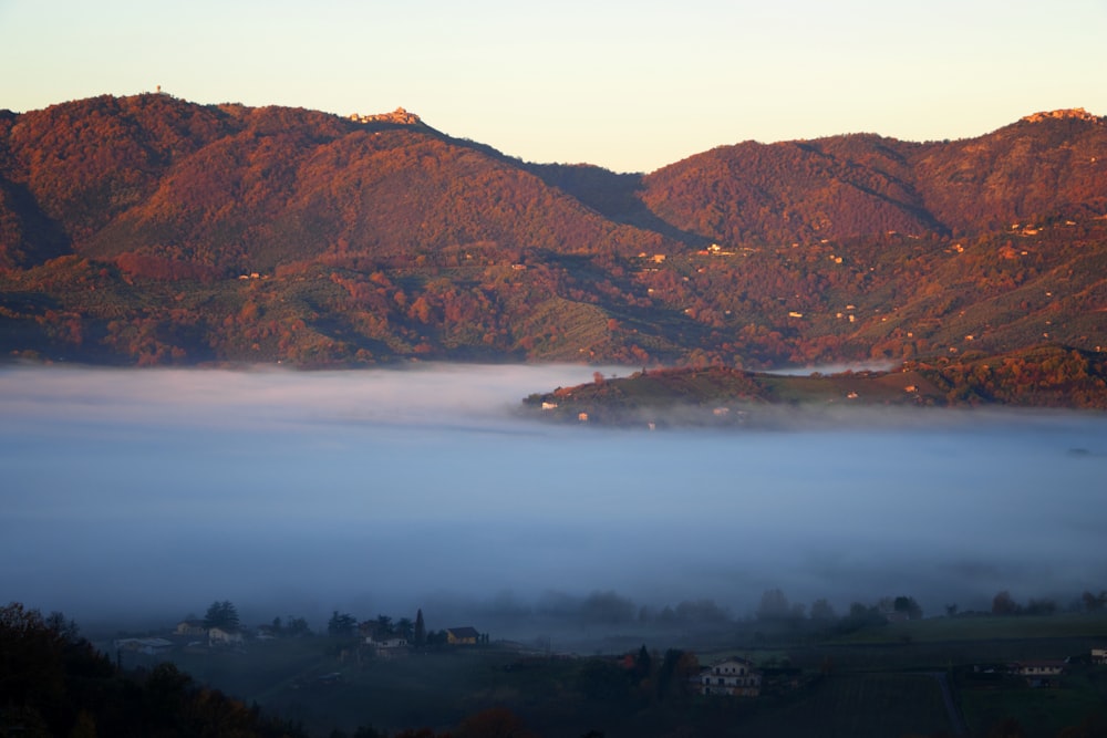 a view of a mountain range covered in fog