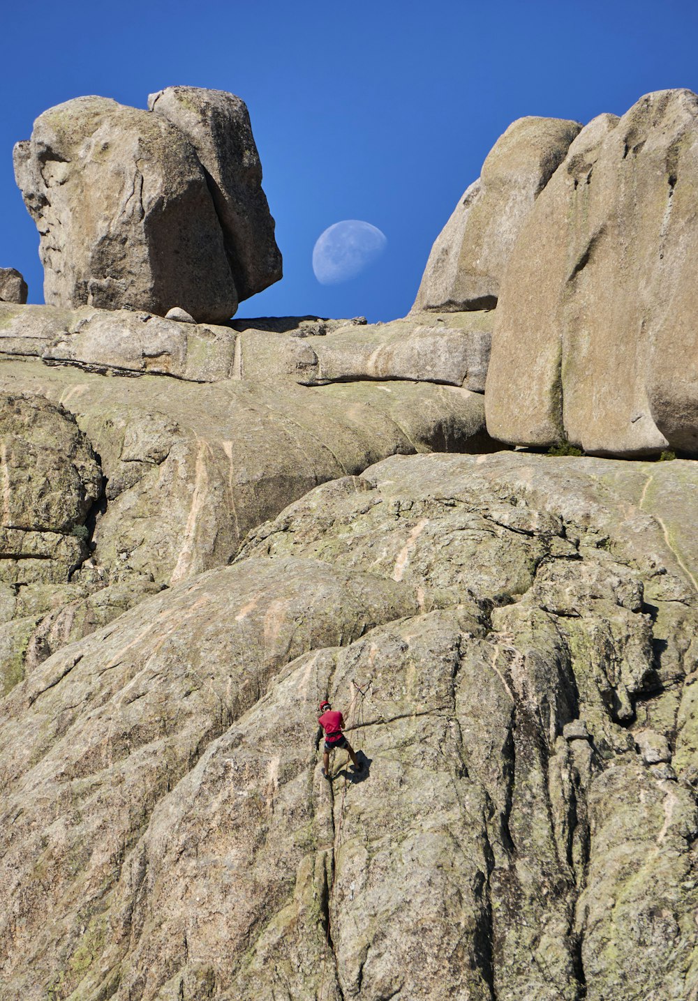 a man climbing up the side of a mountain