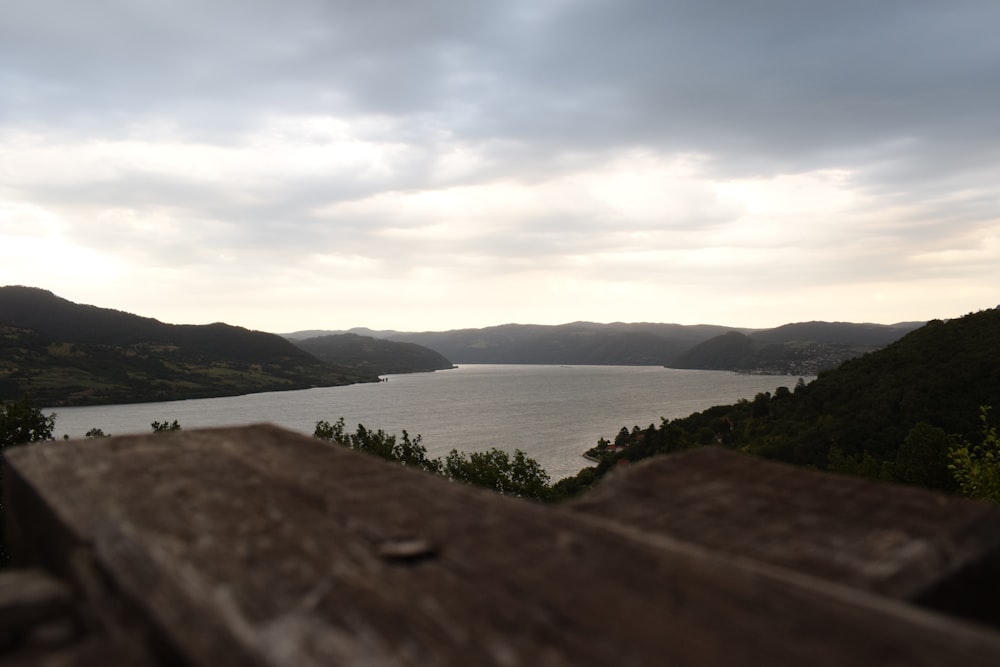 a view of a body of water from a wooden bench