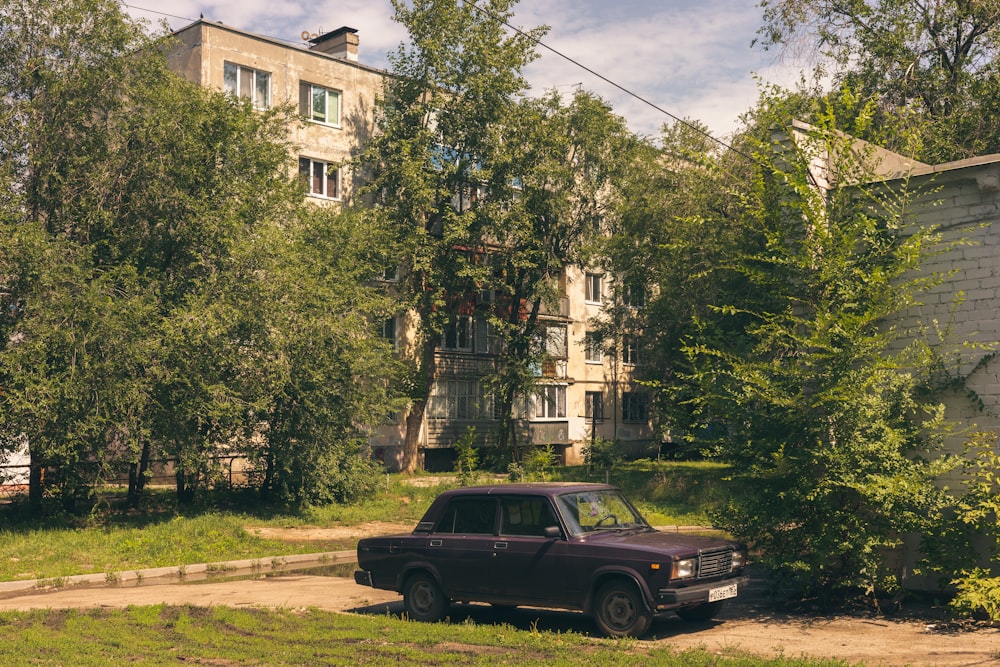 a black truck parked in front of a tall building