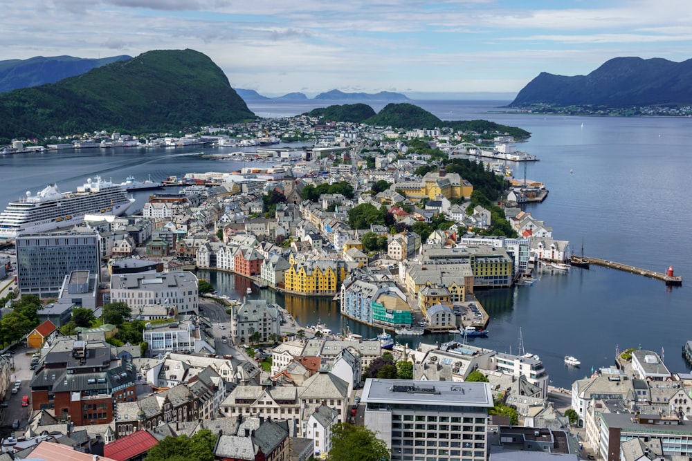 an aerial view of a city with mountains in the background