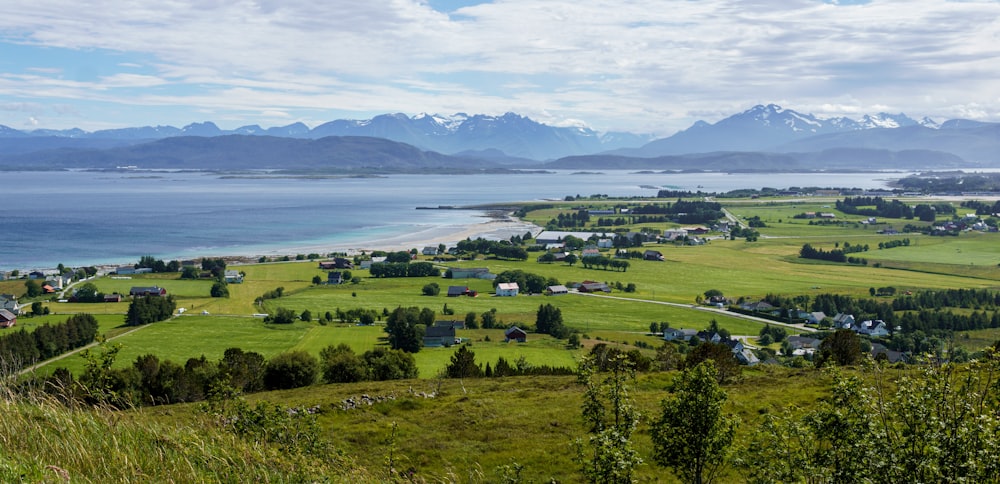 a scenic view of a small town and a body of water