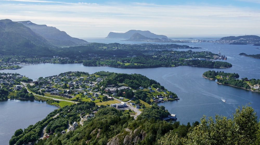 an aerial view of a lake surrounded by mountains