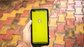 A vibrant smartphone screen showing a lively Snapchat chat interface.