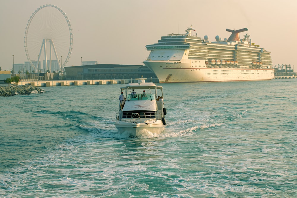 a small boat in the water with a large cruise ship in the background