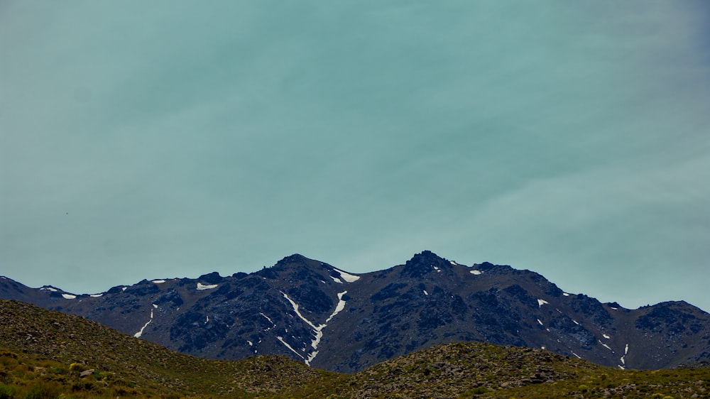 a view of a mountain range with snow on the top