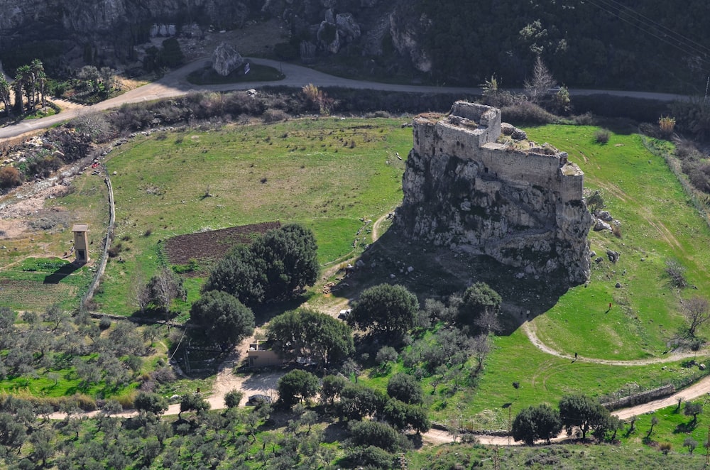 an aerial view of a castle in the middle of a field