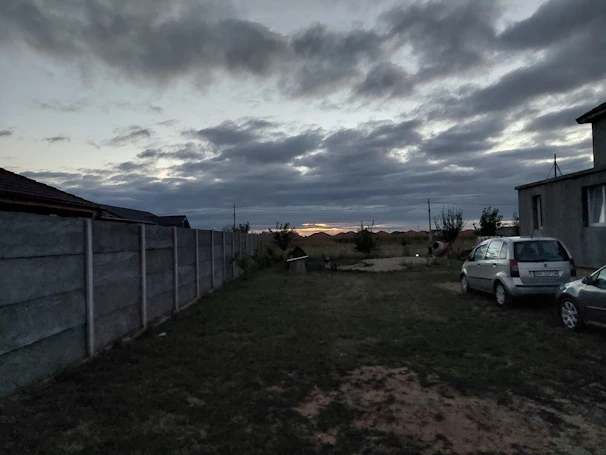 Evening shot of a backyard fenced area with subtle lighting, emphasizing strength and privacy.