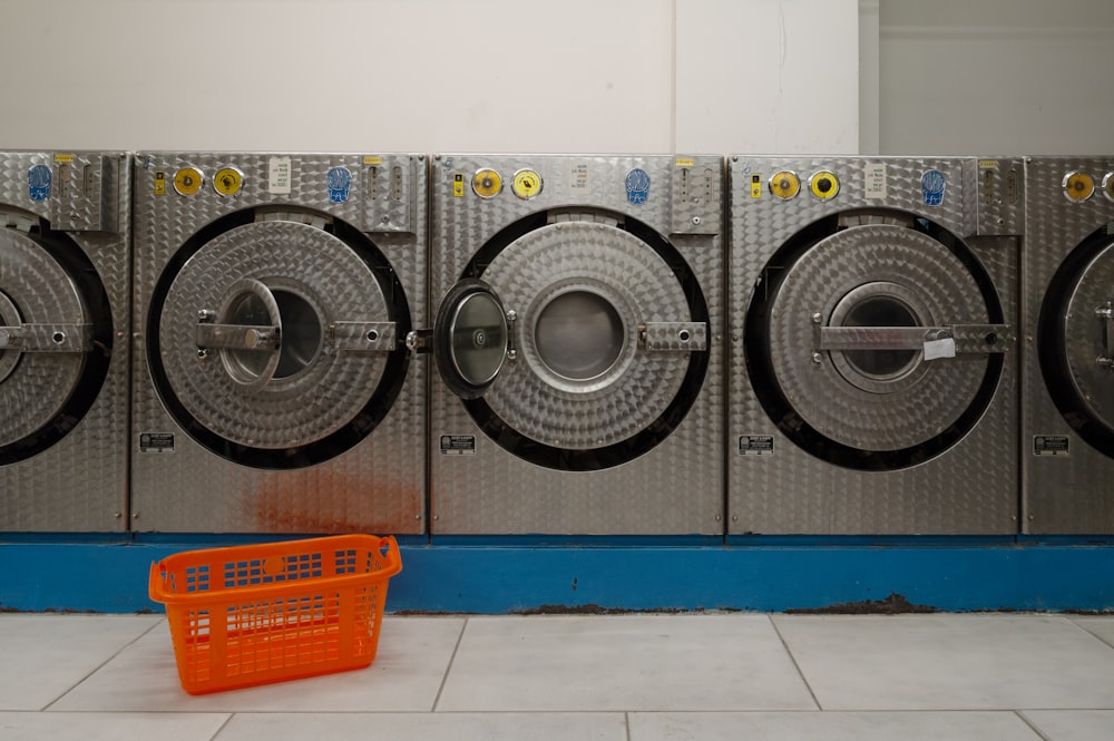 a row of washers in a public laundment
