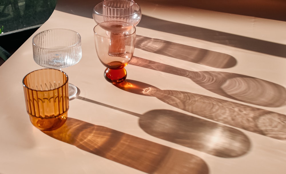a table topped with glasses and a bottle of liquid