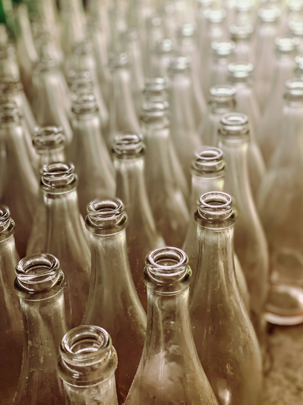 a bunch of empty glass bottles sitting on a table
