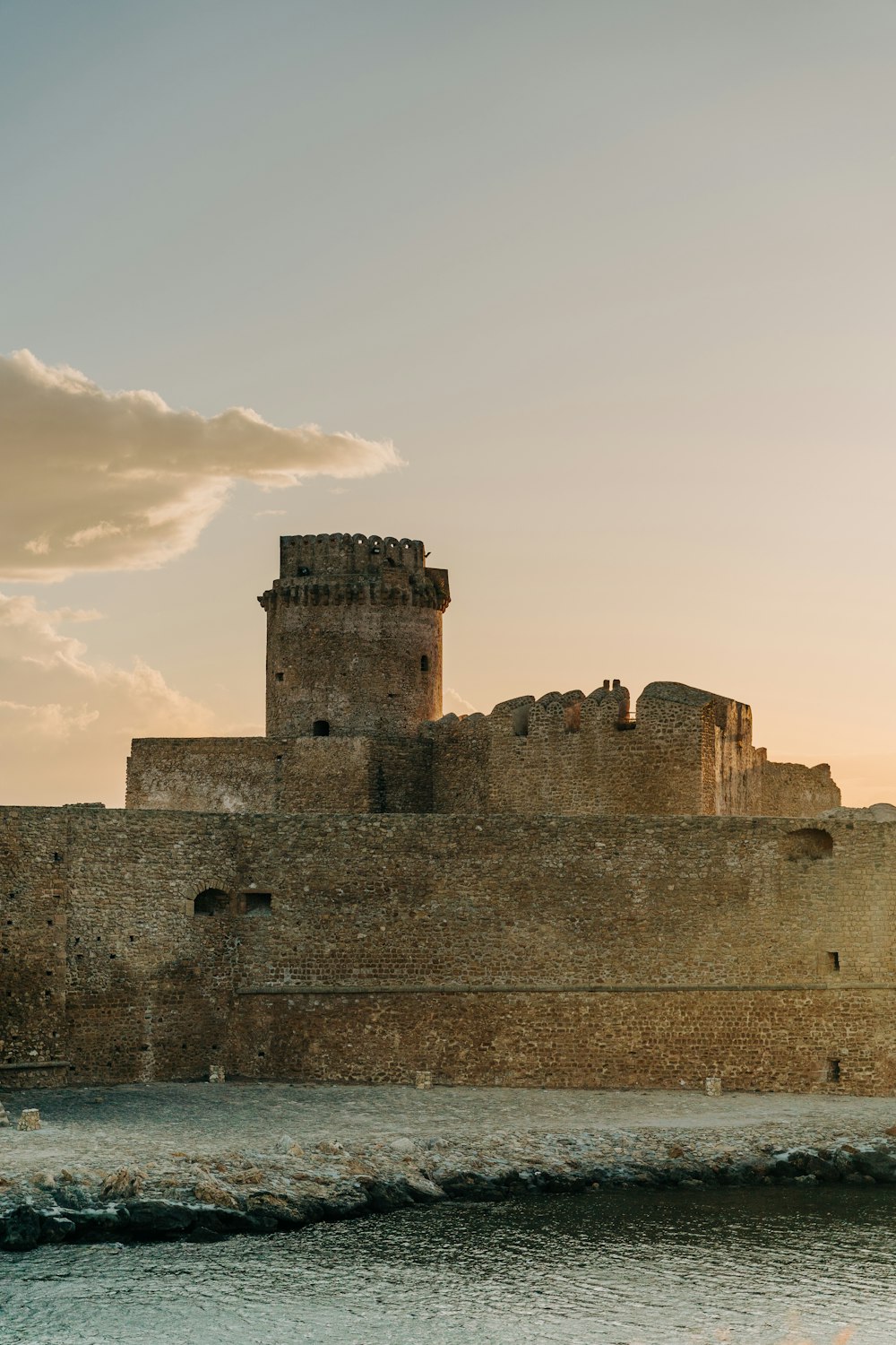 a large castle sitting next to a body of water