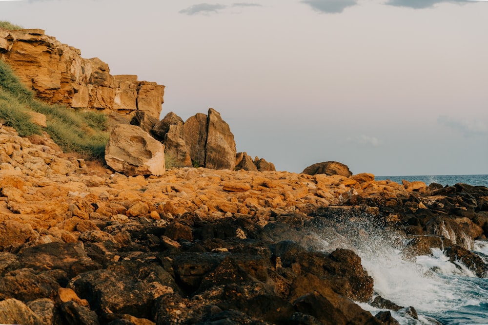 a rocky shore with waves crashing against the rocks