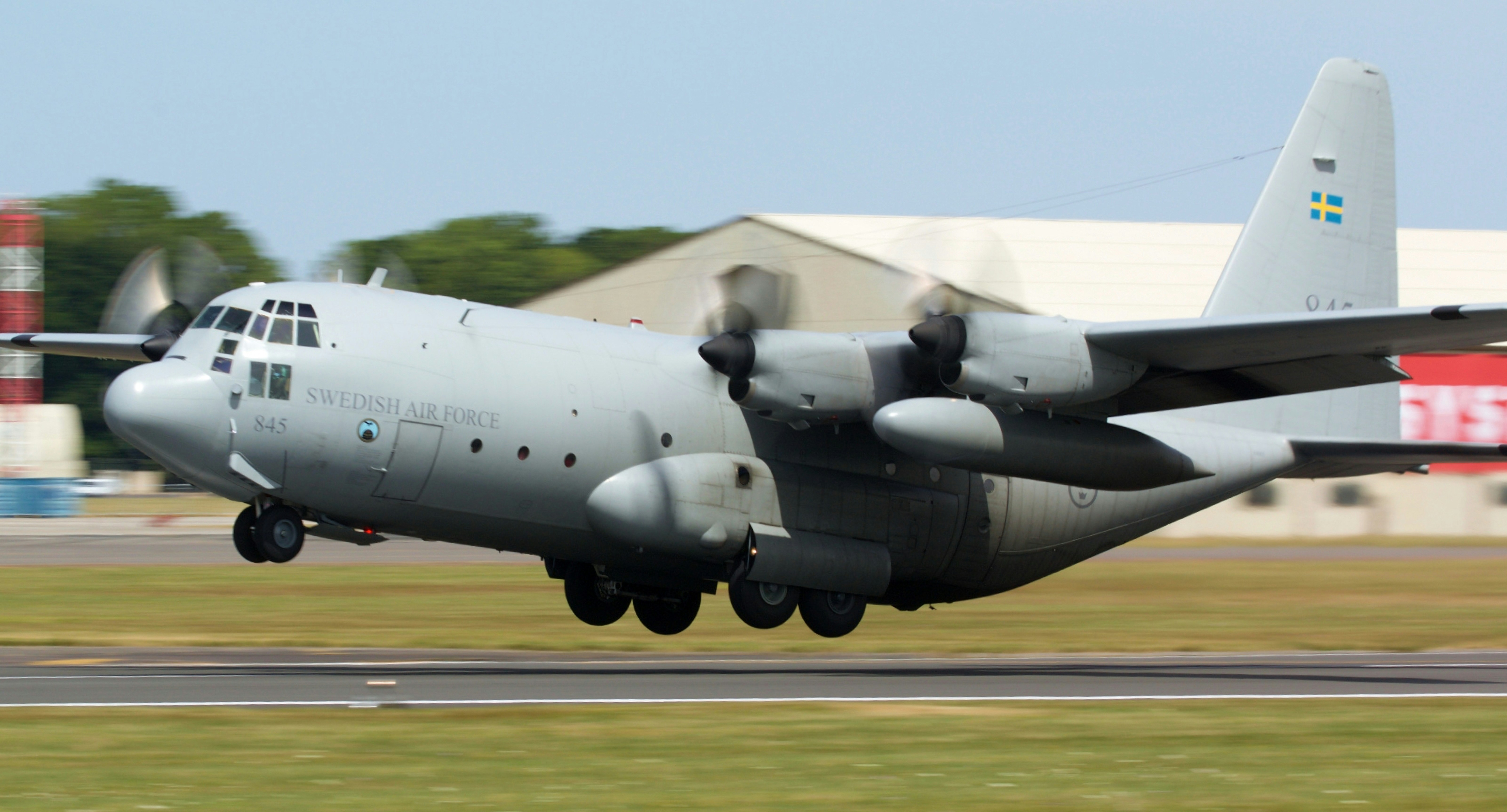 a large air plane taking off from an airport runway, 