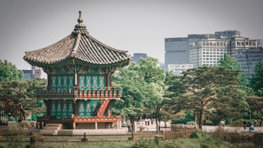 a tall building sitting in the middle of a park
