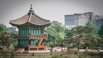 a tall building sitting in the middle of a park