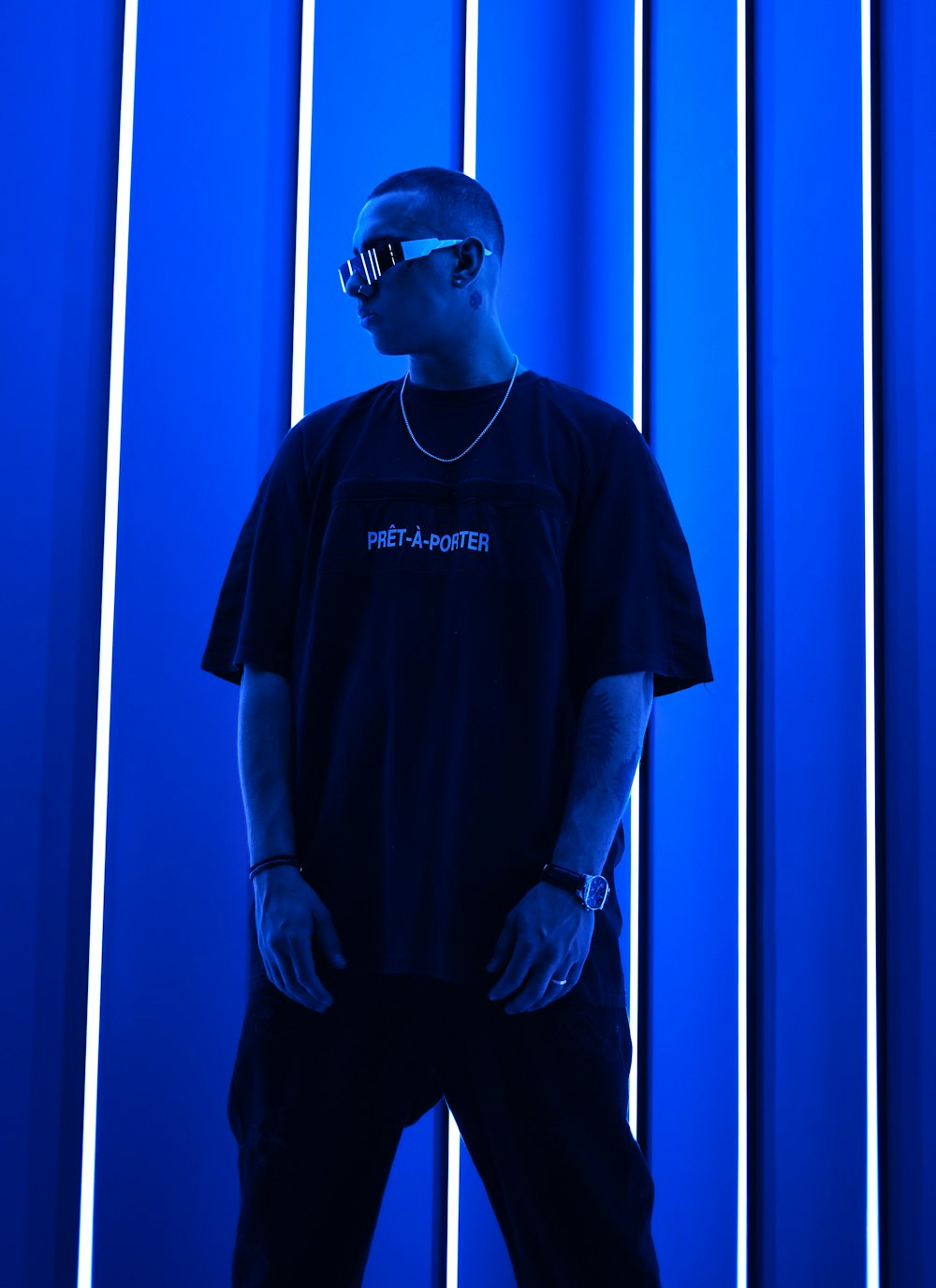 a man standing in front of a blue wall