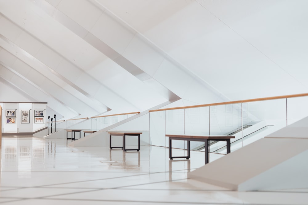 an empty room with benches and tables in it