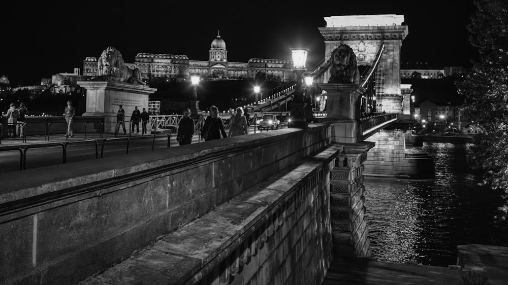 a black and white photo of a bridge at night
