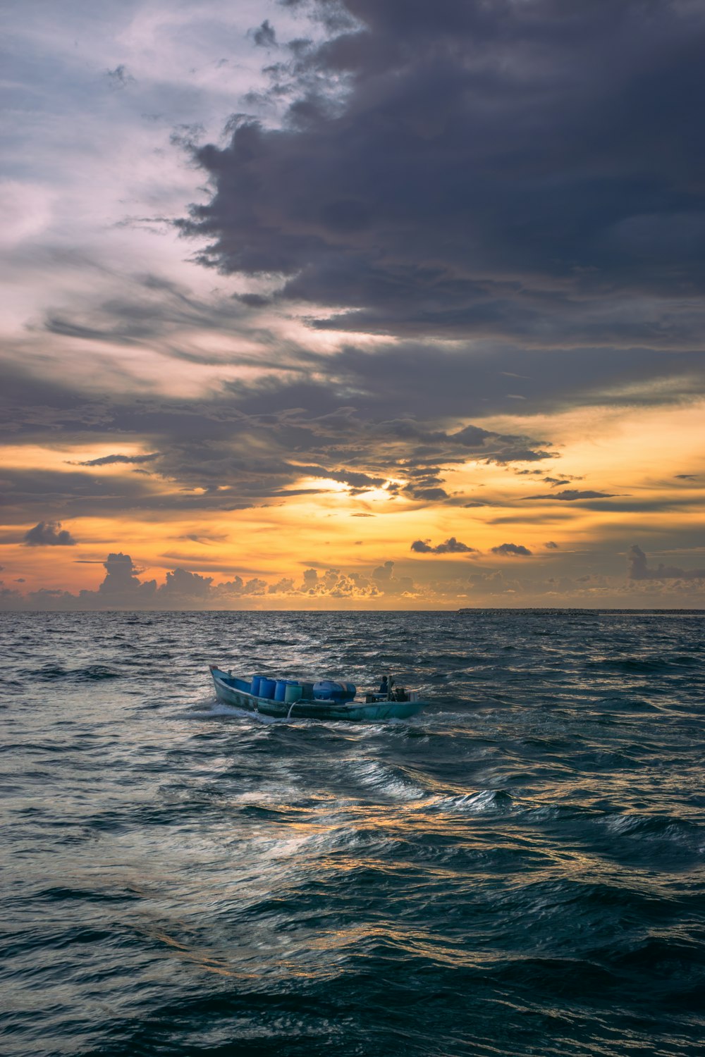 a small boat in the middle of a large body of water