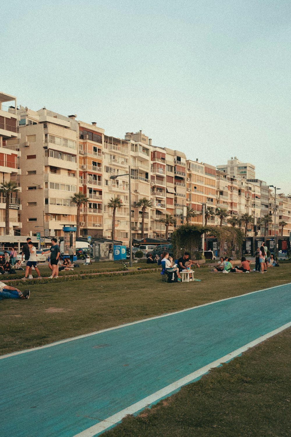 a group of people sitting on a bench in a park