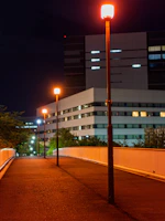 Evening view of a completed development site, with street lamps casting warm glows on the pathways.