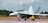 a fighter jet sitting on top of an airport runway