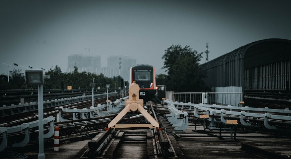 a train traveling down train tracks next to a train station