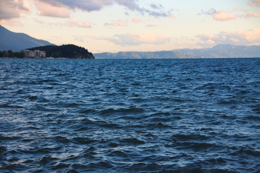 a body of water with a small island in the distance