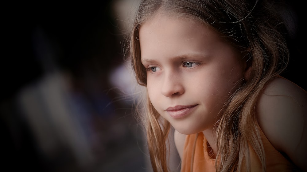 a young girl with long hair and blue eyes