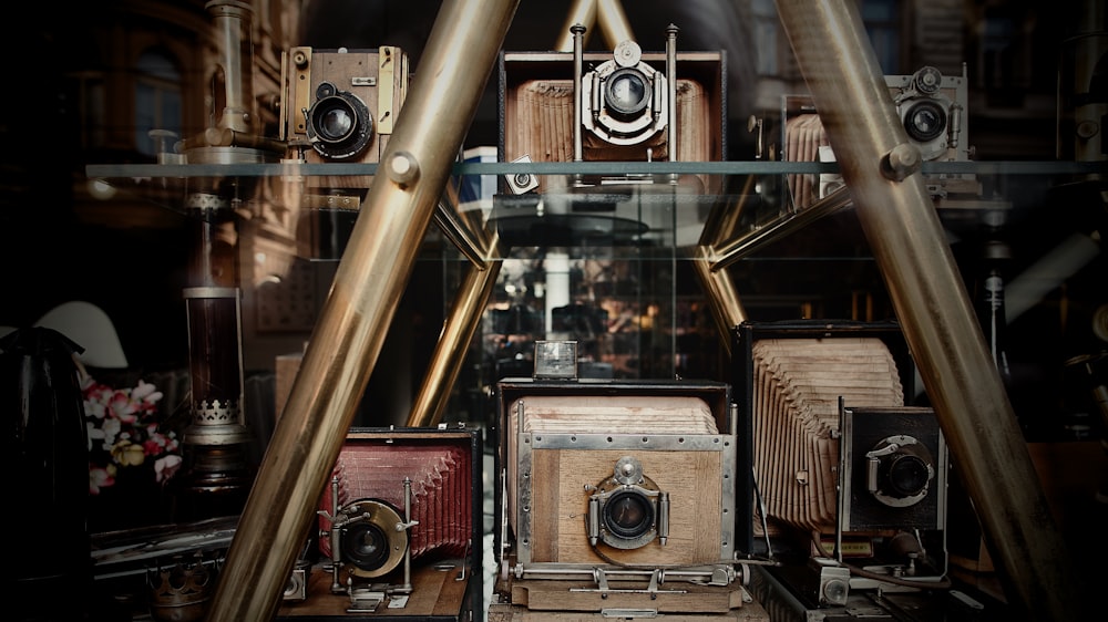 a bunch of old cameras sitting on a shelf