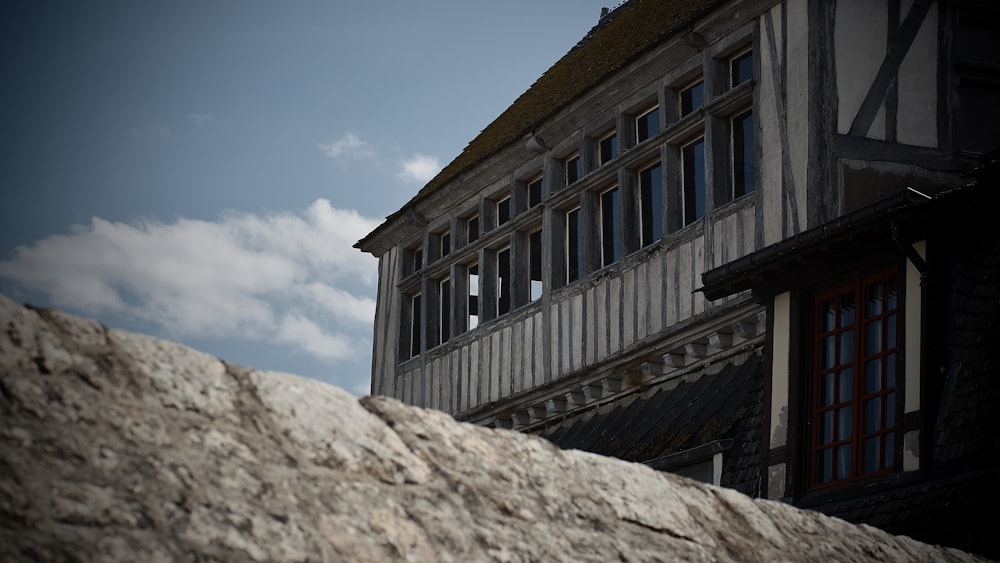 a stone wall with a building in the background