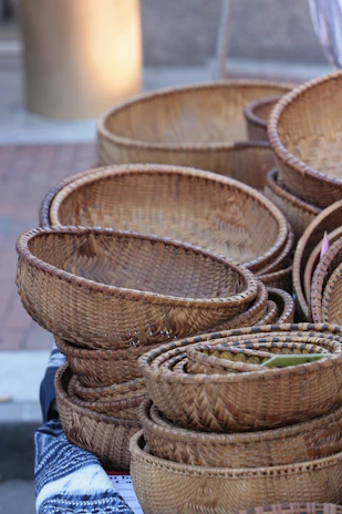 A close-up of colorful woven baskets stacked neatly, showcasing traditional Indonesian craftsmanship.