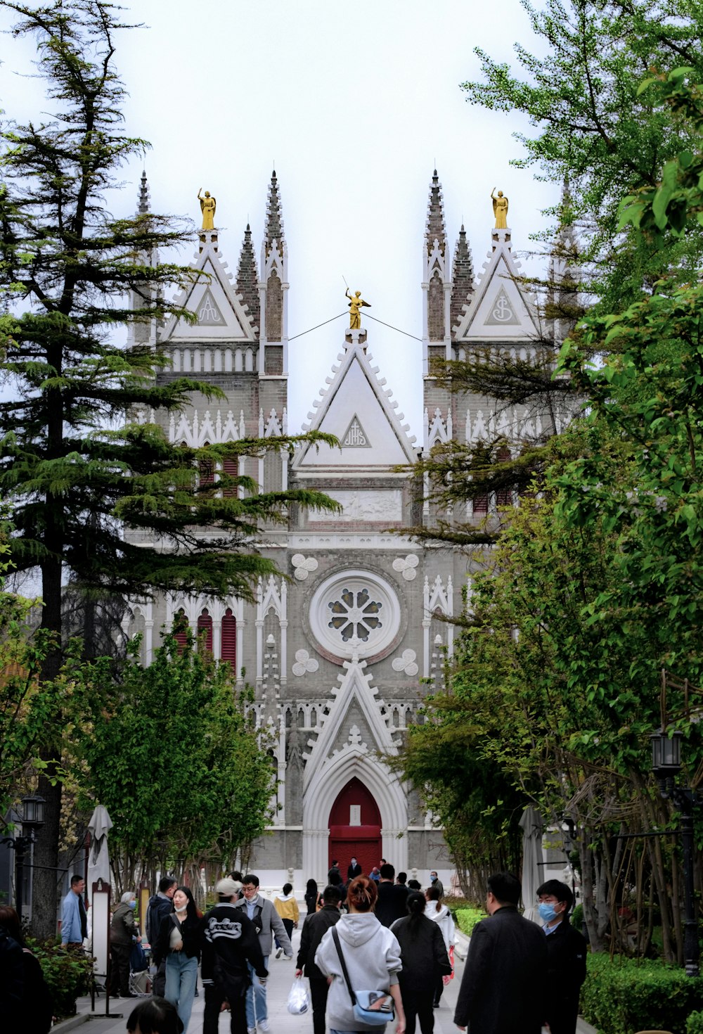 a group of people walking in front of a church