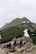 Group of hikers resting with backpacks near a scenic hilltop at Chandrashila peak.