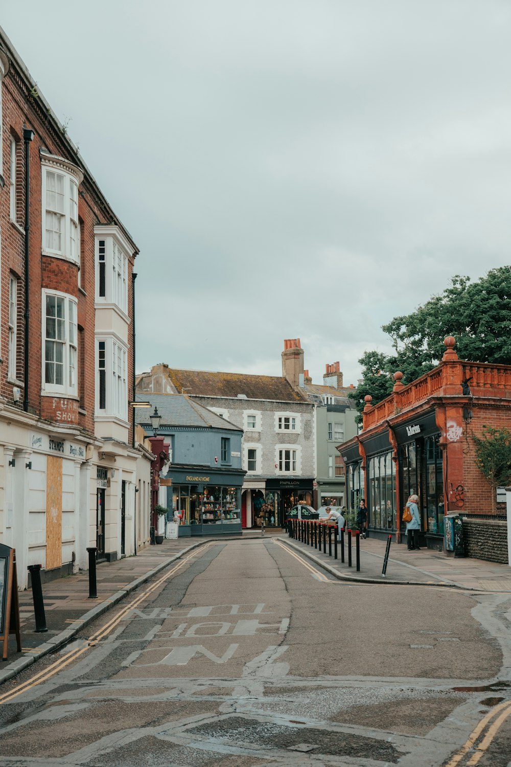 an empty street in a small town on a cloudy day