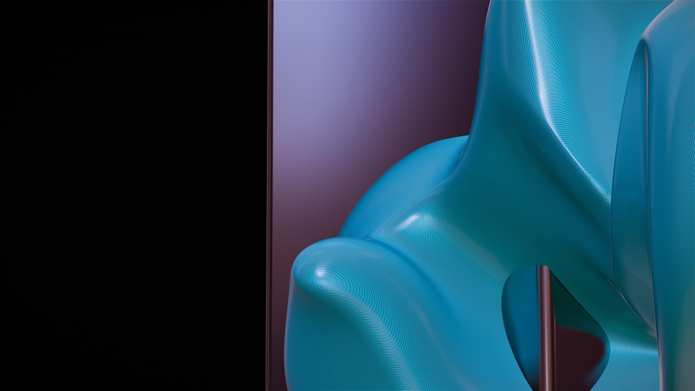 um close up de um objeto azul com um fundo preto