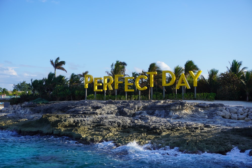 a sign that says perfect day on a beach