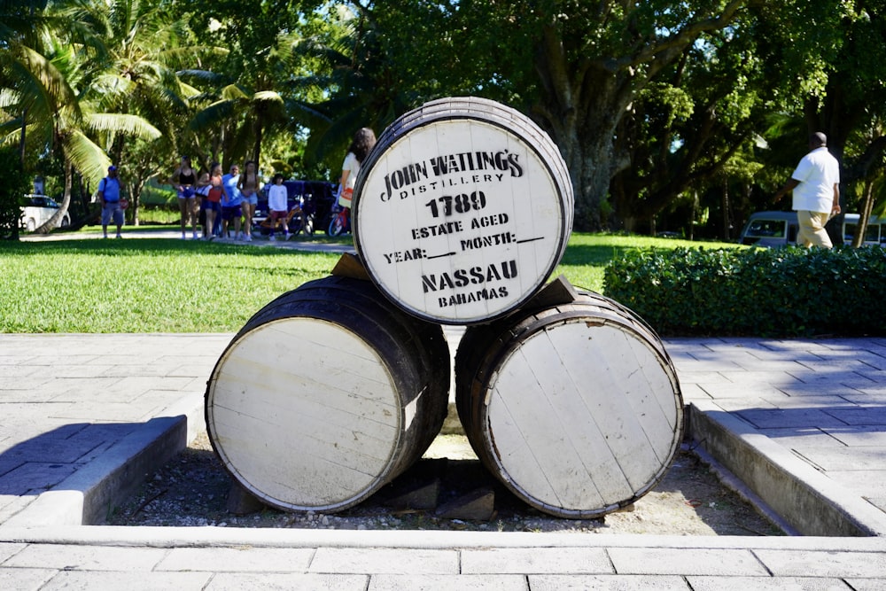 a couple of barrels sitting on top of a sidewalk