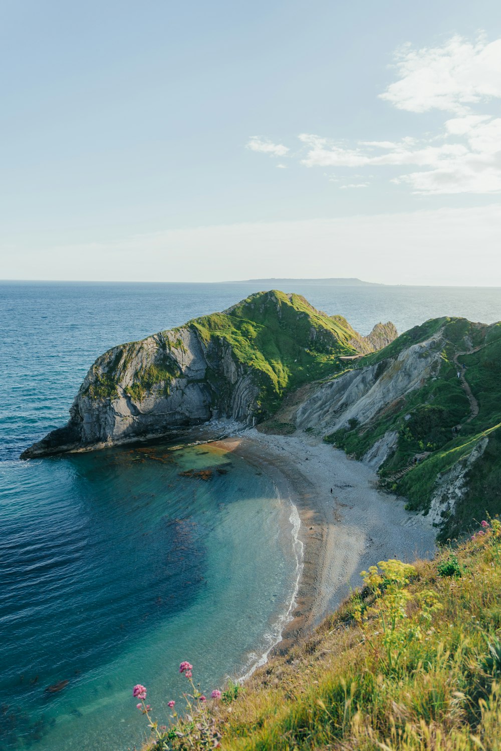 a beach with a small island in the middle of it