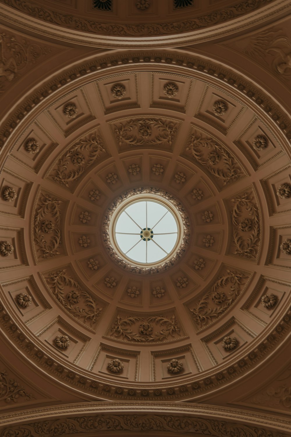 the ceiling of a building with a circular window