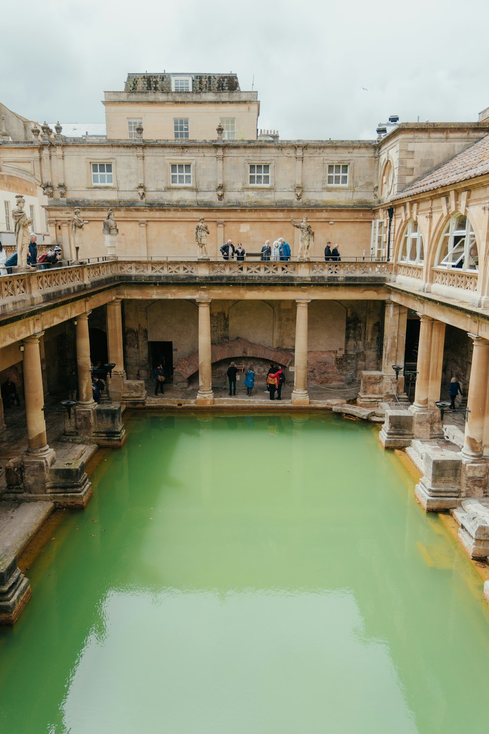 a large pool of green water in a building