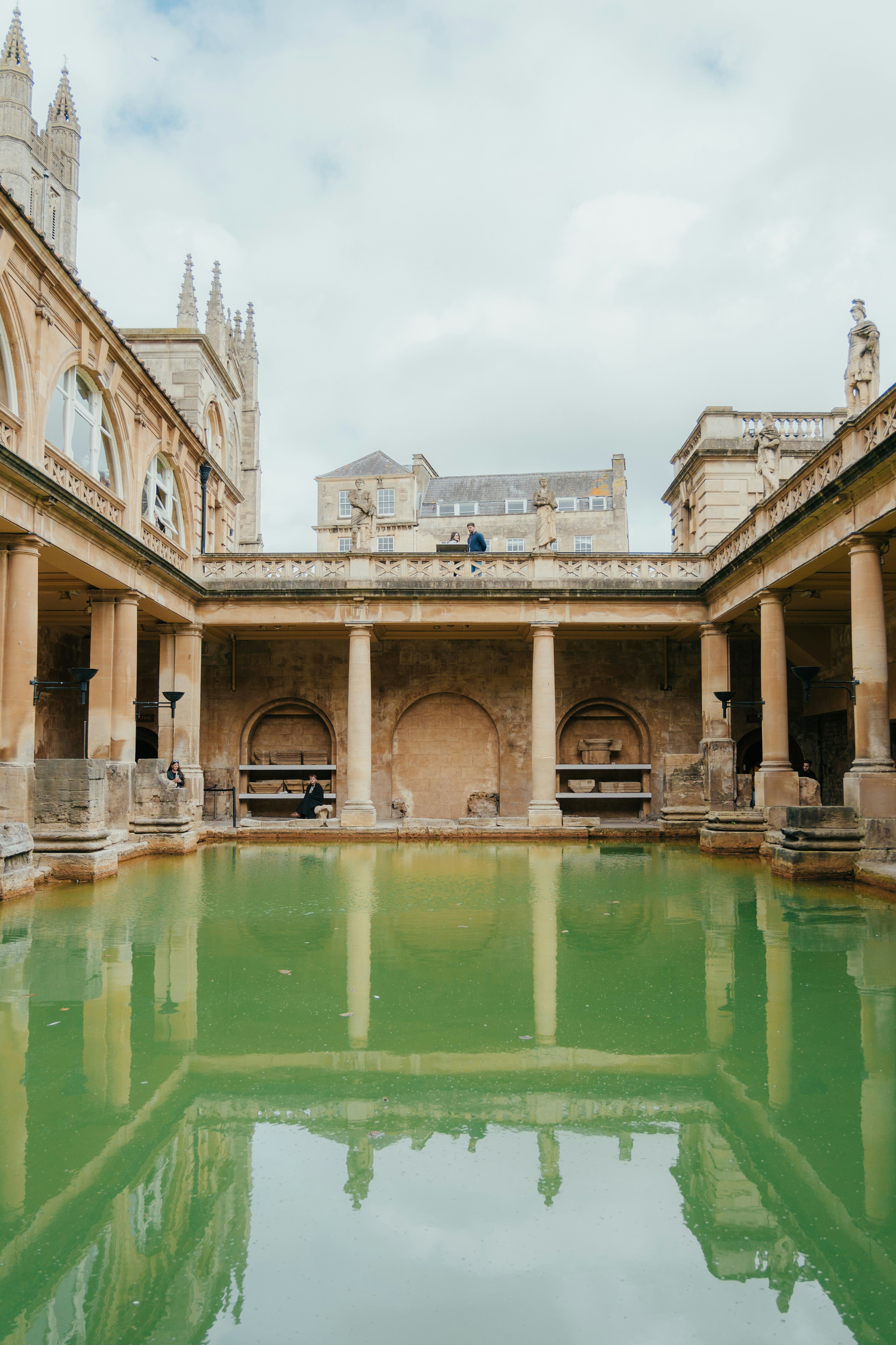 a large building with a pool of water in front of it