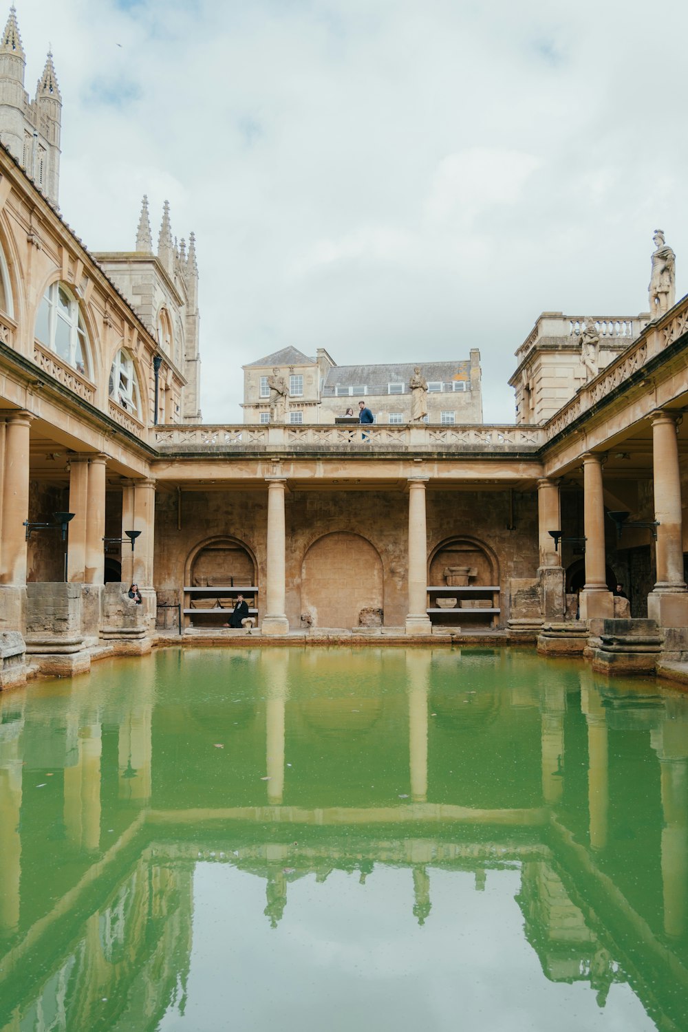 a large building with a pool of water in front of it