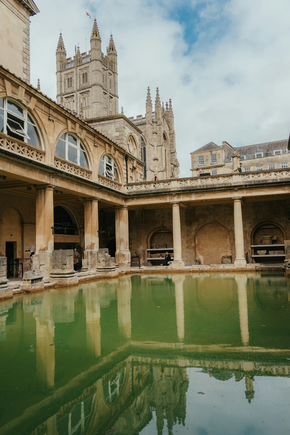 a large building with a pool of water in front of it