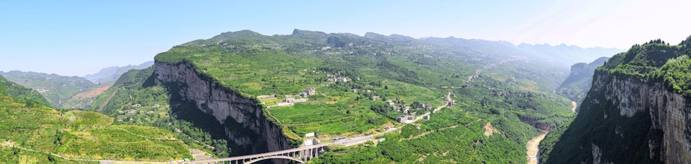 a bridge over a river surrounded by mountains