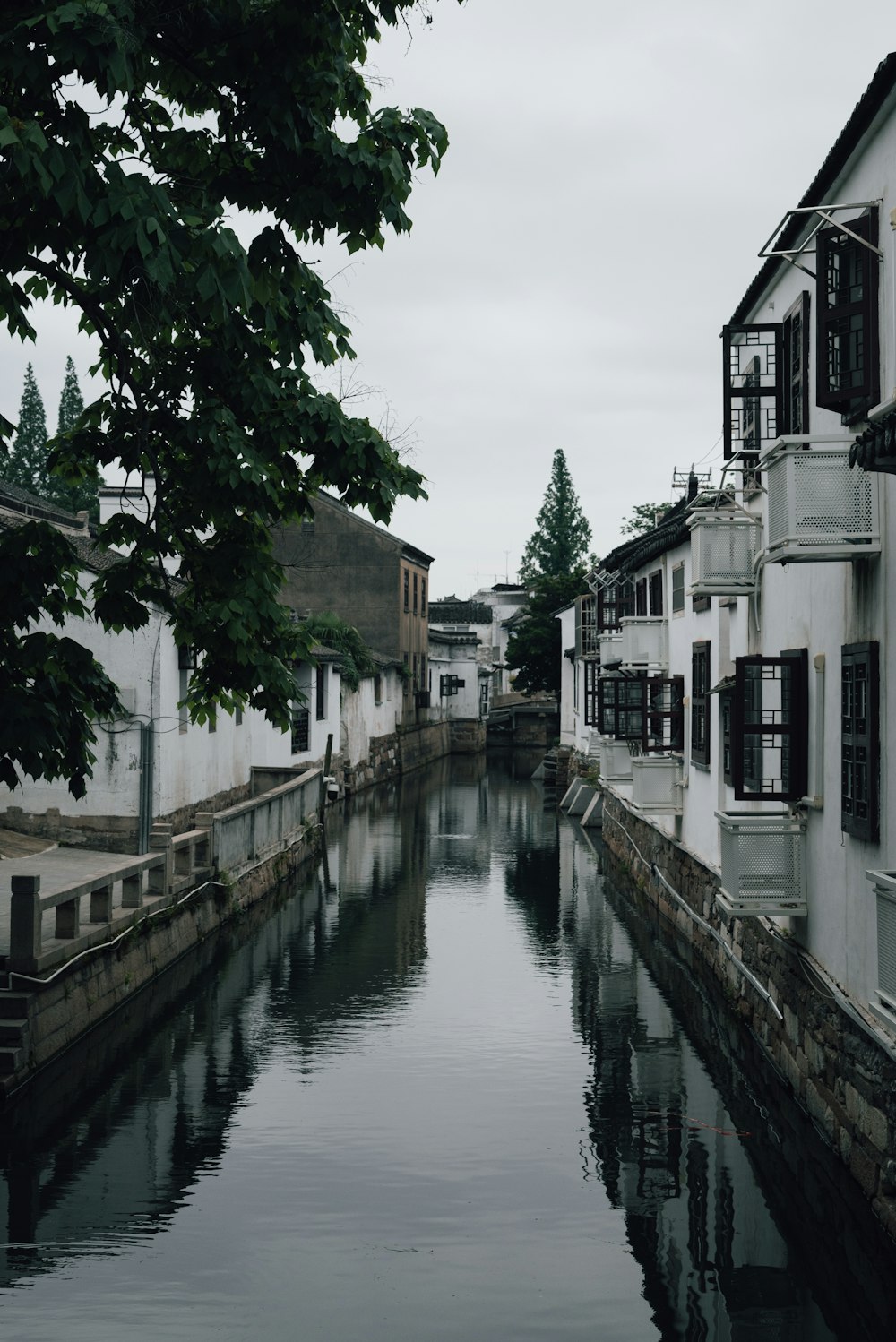 a river running through a city next to tall buildings