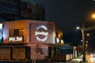 Evening shot of the cozy Heladería Frutikas storefront lit with warm lights.